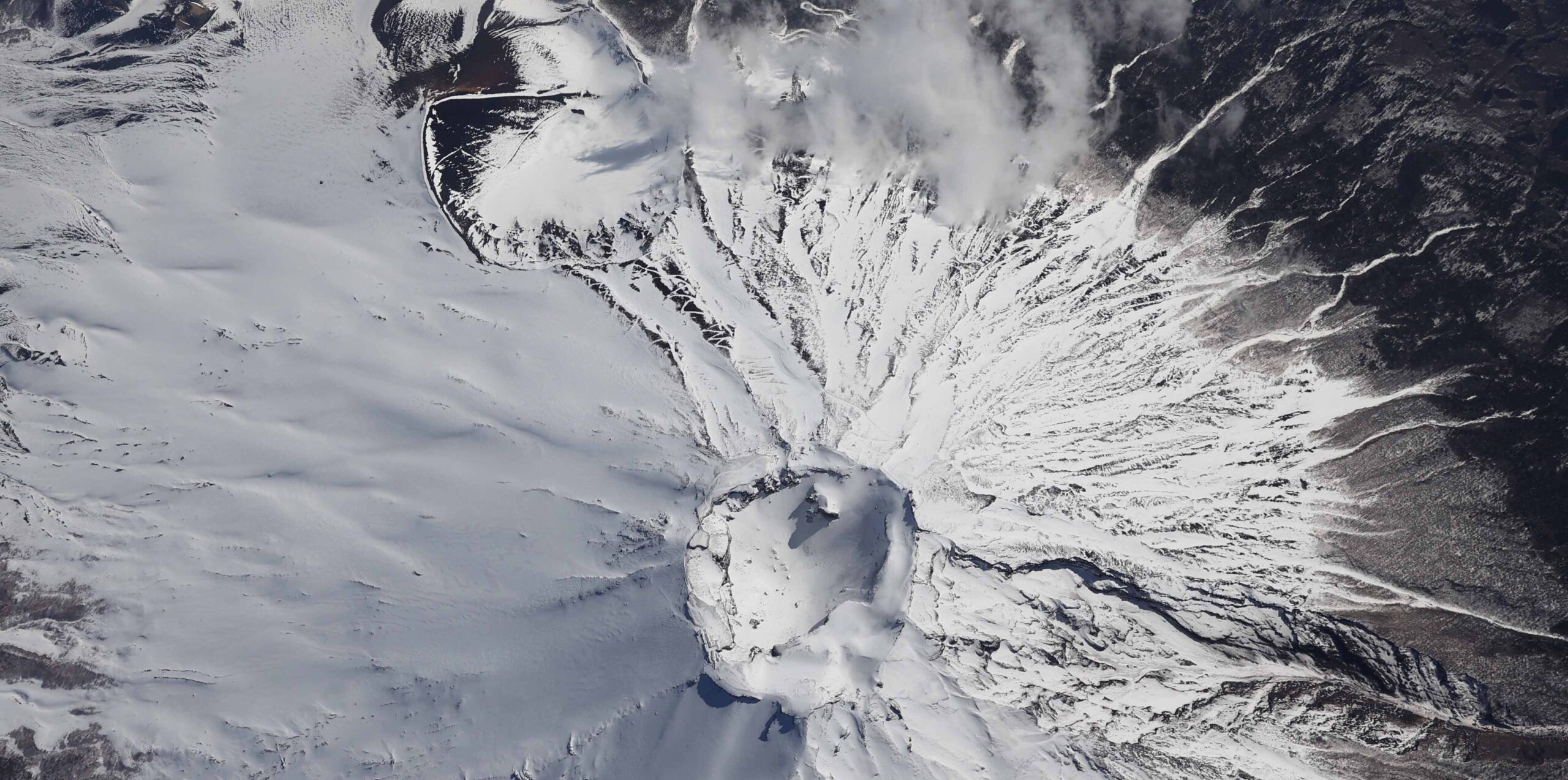 富士山頂の火口＝2020年3月18日午後2時8分、山梨・静岡県境、朝日新聞社機から